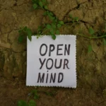 Graphic featuring the text "Open your mind" to help readers learn how to stop negative overthinking and break the rumination cycle.